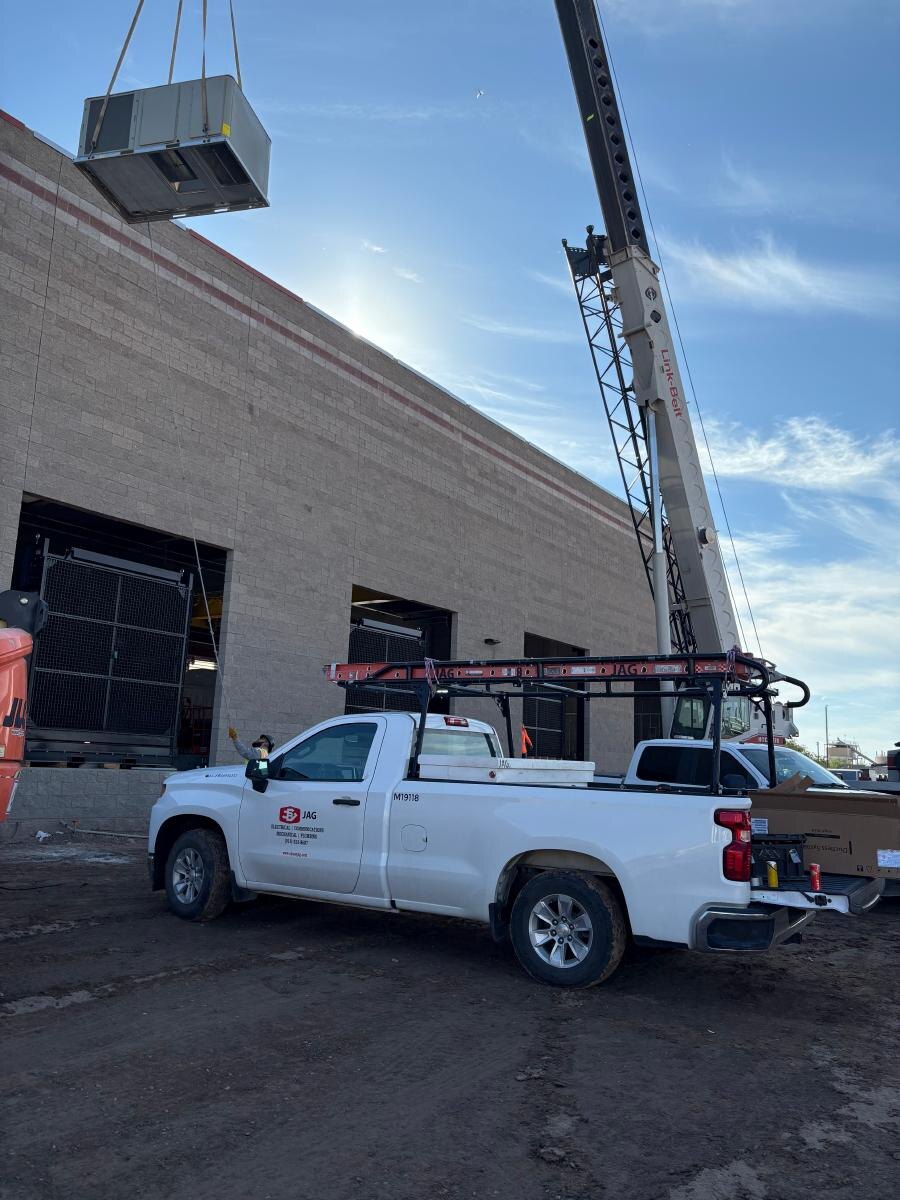 Barrett and JAG crews supporting a crane-assisted rooftop HVAC installation